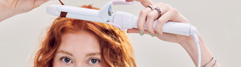 Woman with red hair curling hair with Mane's Power Bottom Base and 1” Curling Iron Styling Attachment