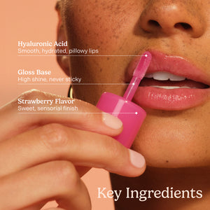 Lip balm being applied to lips with text highlighting key ingredients on a peach background