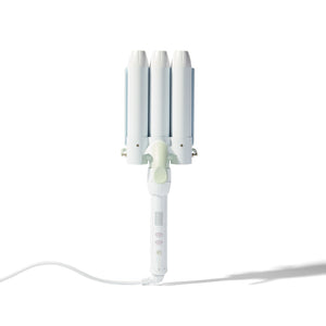 A white triple-cylinder curling iron with three curved barrels, a light green center button, and a white power cord, shown on a clean white background with a soft shadow.