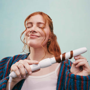 woman using Let's Bounce 1” (25MM) Curling Wand to curl hair
