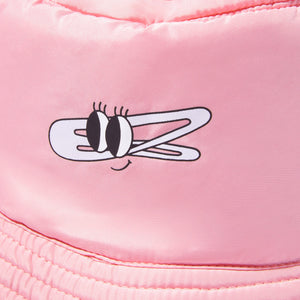 Smiling woman wearing a pink bucket hat with a white front logo