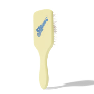 Ready or Knot Detangling Brush in pale yellow with a blue logo and bristles along the right edge