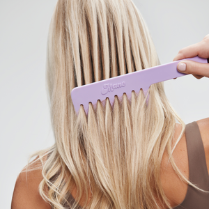woman brushing hair with Knot Ur Avg Wide-Tooth Comb