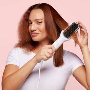 woman using Mane’s Hot Straightening Brush to style hair