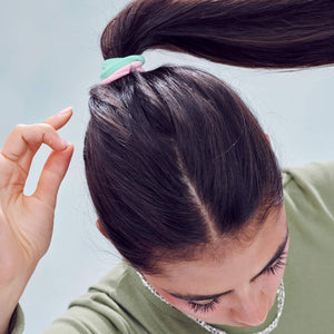 aerial shot of woman using Rainbow Fabric Hair Ties to tie up hair