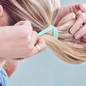 model tying hair with Rainbow Fabric Hair Ties