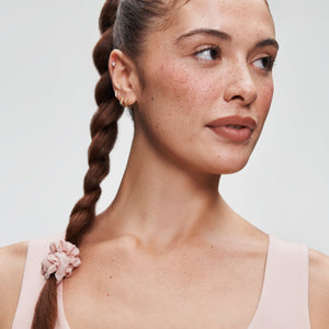 Woman hair styled into a braid with Soft Serve Hair Tie at bottom