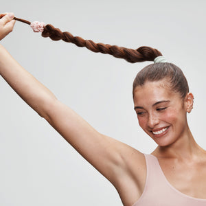 Woman with braid holding up end of hair