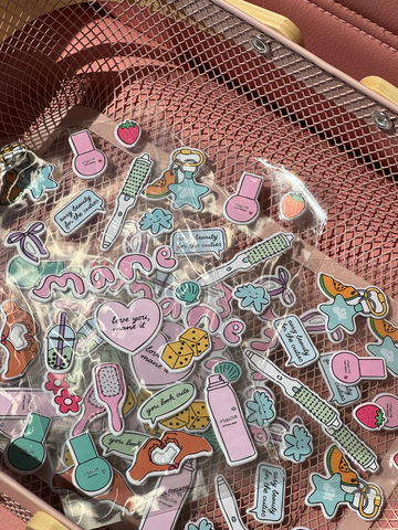 Collection of colorful stickers on a pink mesh surface