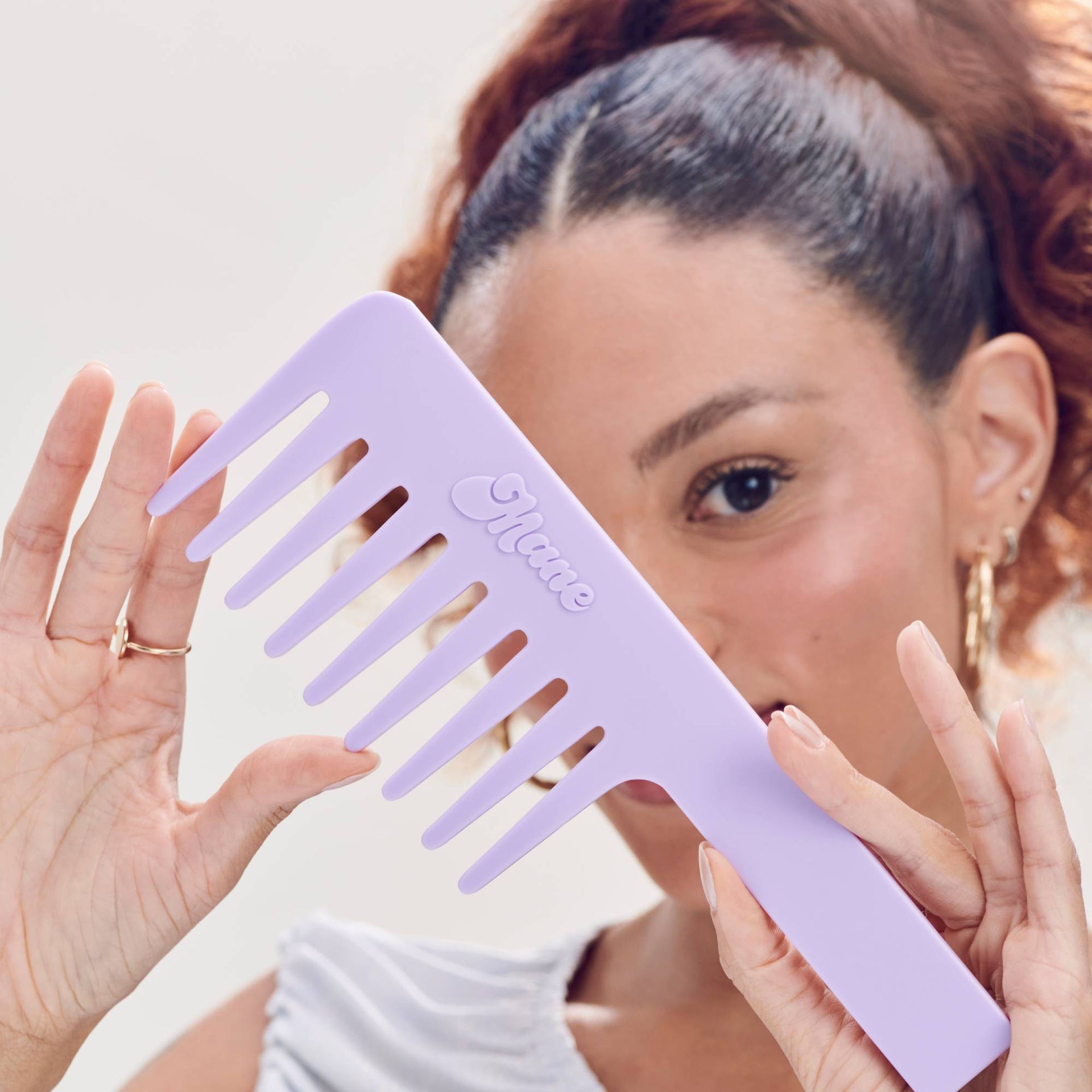 mane by jen atkin not ur average wide-tooth comb in purple with model