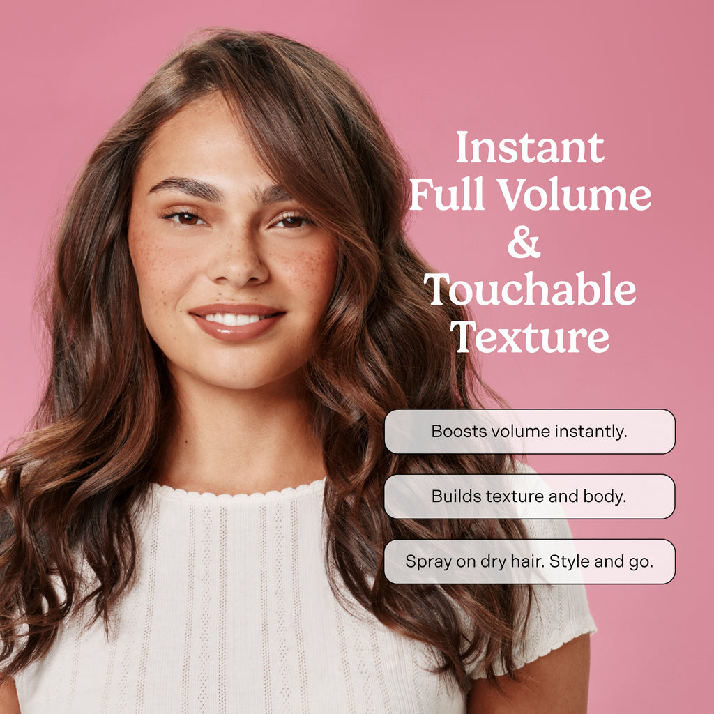 Woman with styled hair against a pink background with product features text. Instant full volume & touchable texture. 