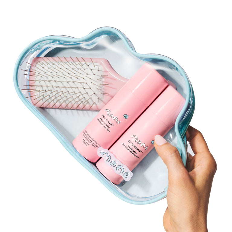 Cloud-shaped case with pink hairbrush and bottles labeled 