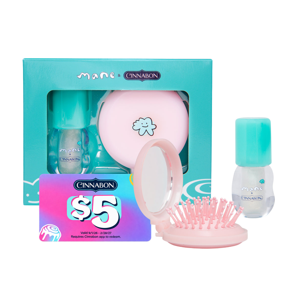 Maeve Cinnamon travel beauty set featuring a turquoise box, a pink round mirror, a pink hairbrush, and two teal/cyan bottles, displayed on a clean white background.