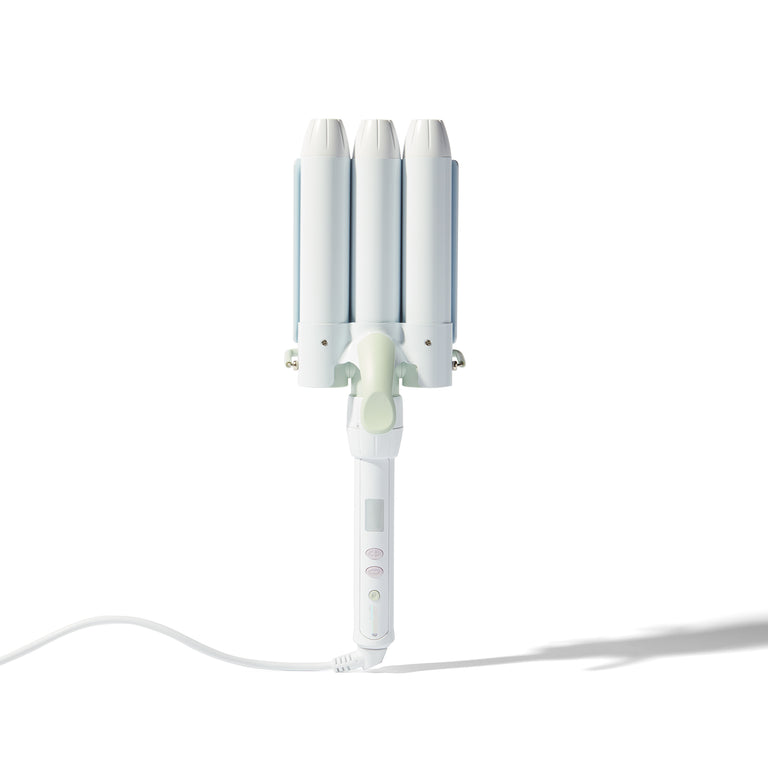 A white triple-cylinder curling iron with three curved barrels, a light green center button, and a white power cord, shown on a clean white background with a soft shadow.