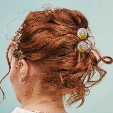 Smiley hair clips on model