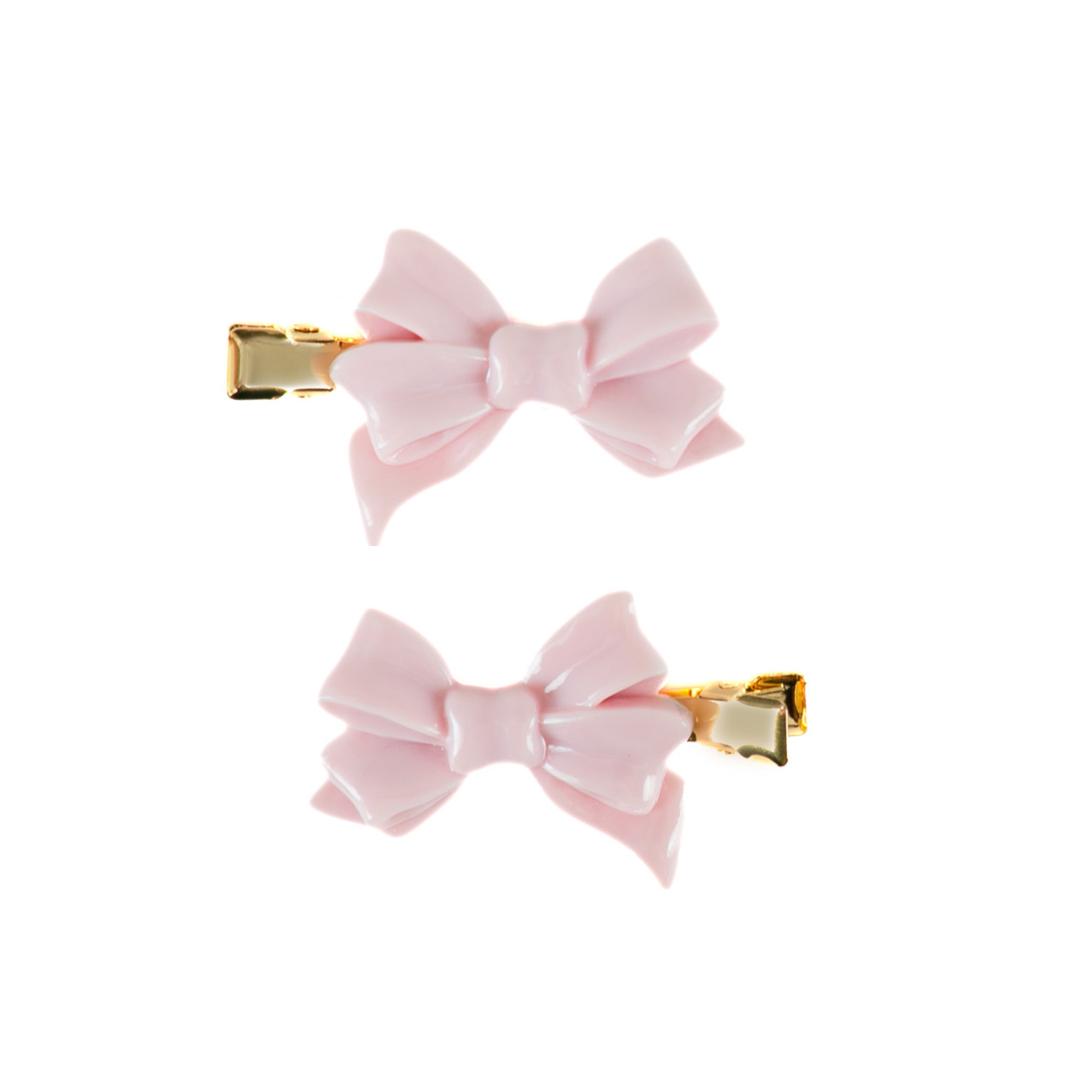 Two small pink bow hair clips with gold-tone metal clasps, shown on a plain white background.