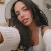 video of woman getting ready to style her hair using hair products