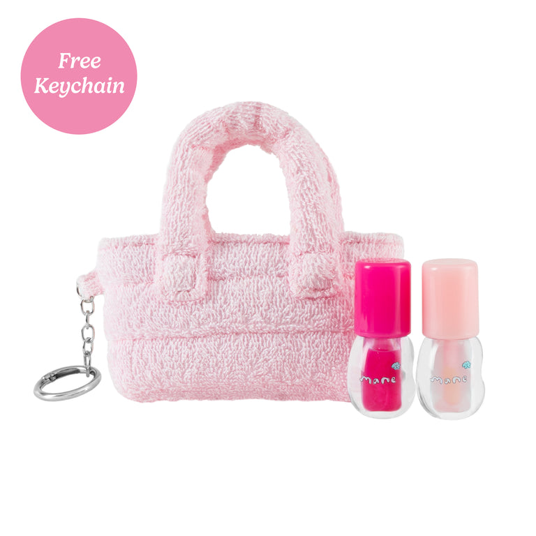 Sugar Shore lip gloss, Strawberry Island lip gloss, and pink mini tote keychain, on a white background with text in the corner that reads "Free Keychain"